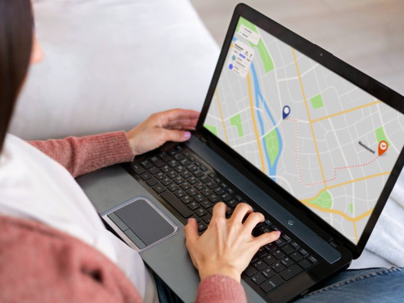 Laptop showing a map with a delivery route and location pins for shipment tracking